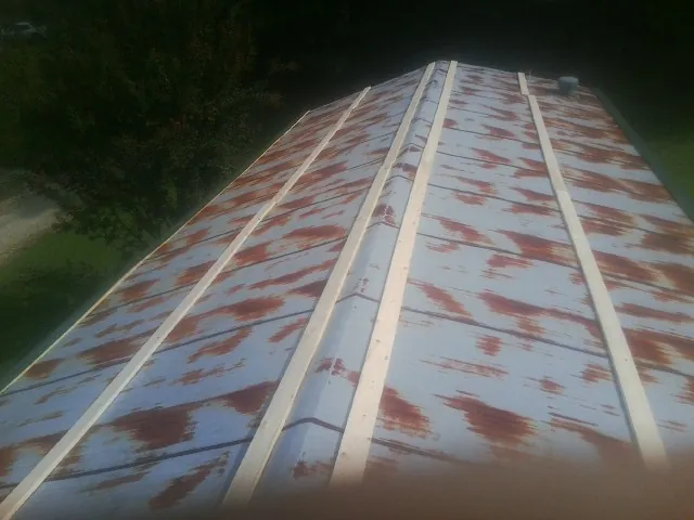 Rusted metal roof panels with new wood purlins before replacement — Storm Damage Roof Repair in Downingtown by Roofing Brothers