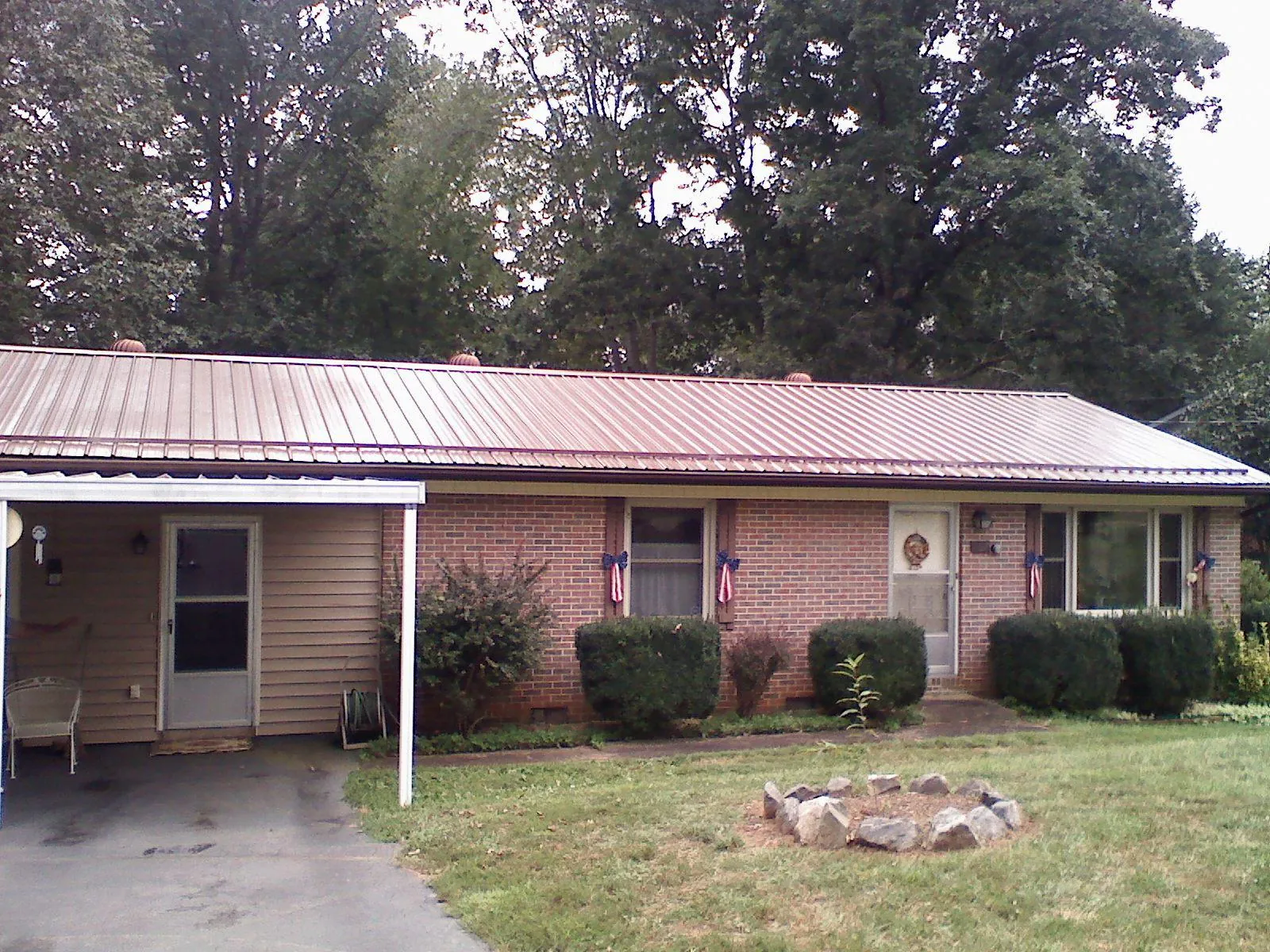 Bronze metal roof and carport on a brick ranch home — Roof Repair work by our crew in Downingtown