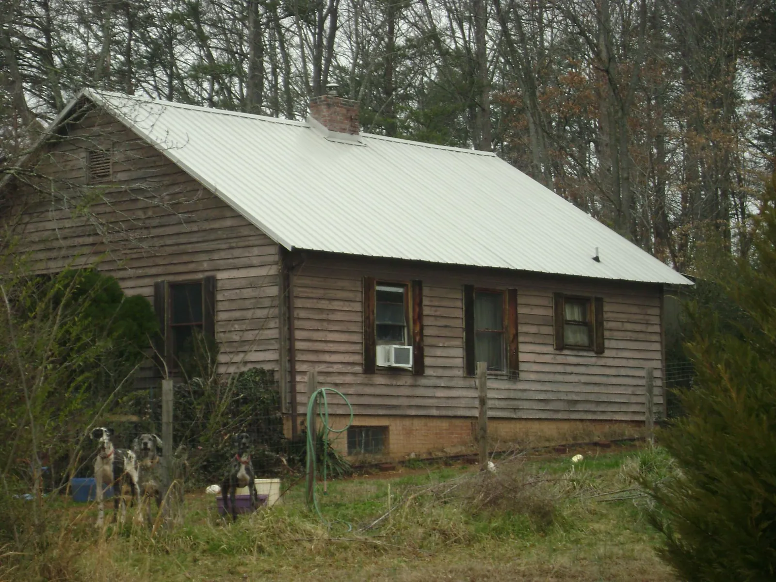 White metal roof on an old wood sided farmhouse, from a Metal Roof Installation job in Downingtown